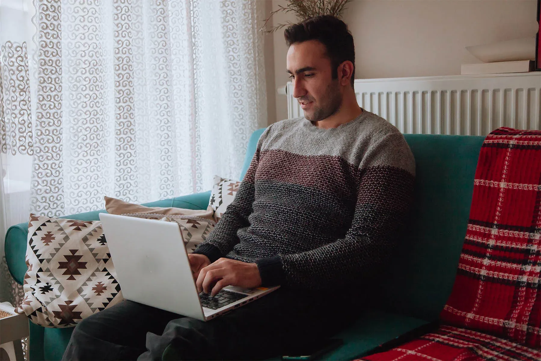 A man checking coverage details on a laptop at home